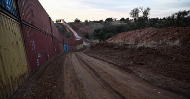 Shipping containers stacked at the U.S.-Mexico border