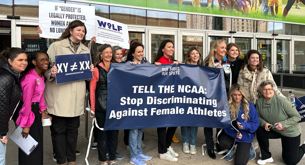 women protest NCAA rule allowing males to compete in women's sports