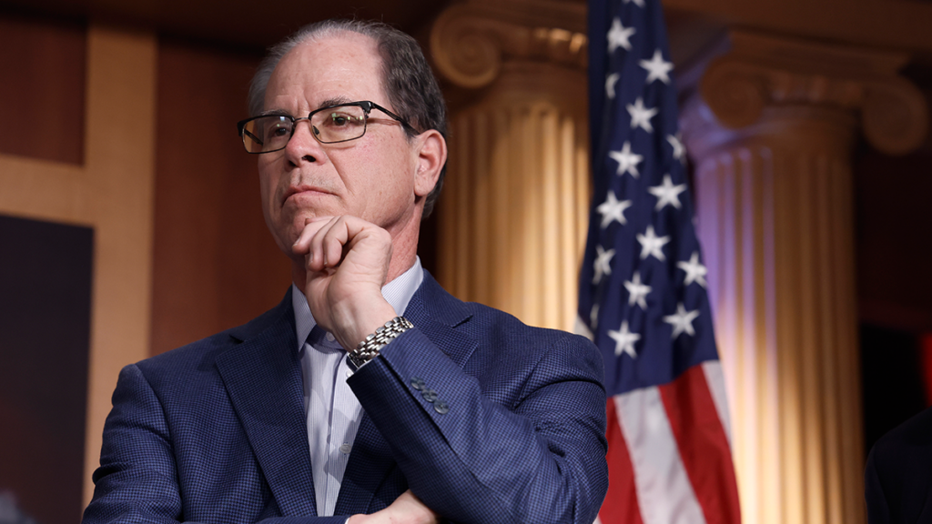 Sen. Mike Braun in front of an American flag