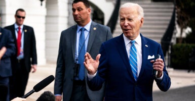 Joe Biden gestures in a blue suit