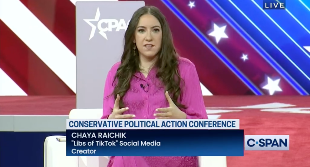 Chaya Raichik speaks in front of a CPAC logo