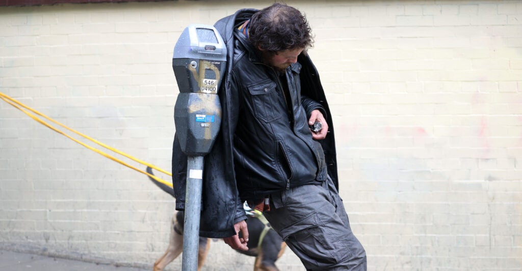 A homeless man loiters Jan. 13 on a sidewalk near San Francisco City Hall.