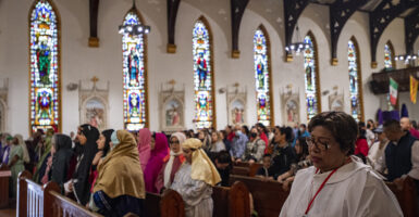 Christians observe Good Friday in a Catholic church.