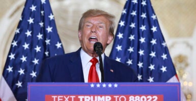 Donald Trump in front of American flags