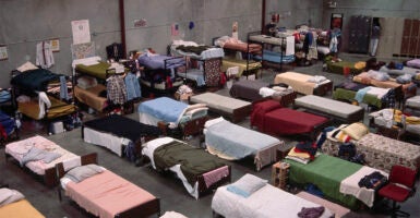 Rows of beds inside a homeless shelter