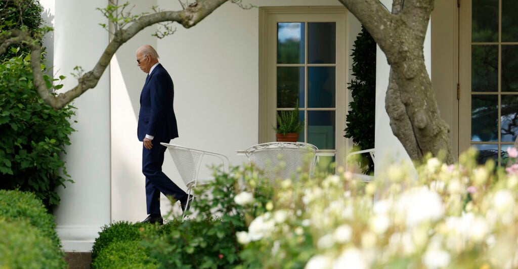 President Joe Biden walks in front of the White House.