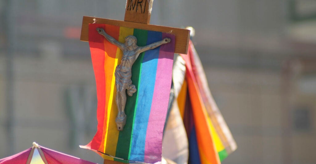 A crucifix with a rainbow flag