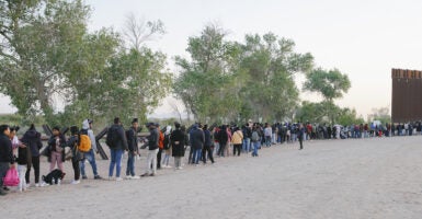 Migrants line up at the U.S.-Mexico border