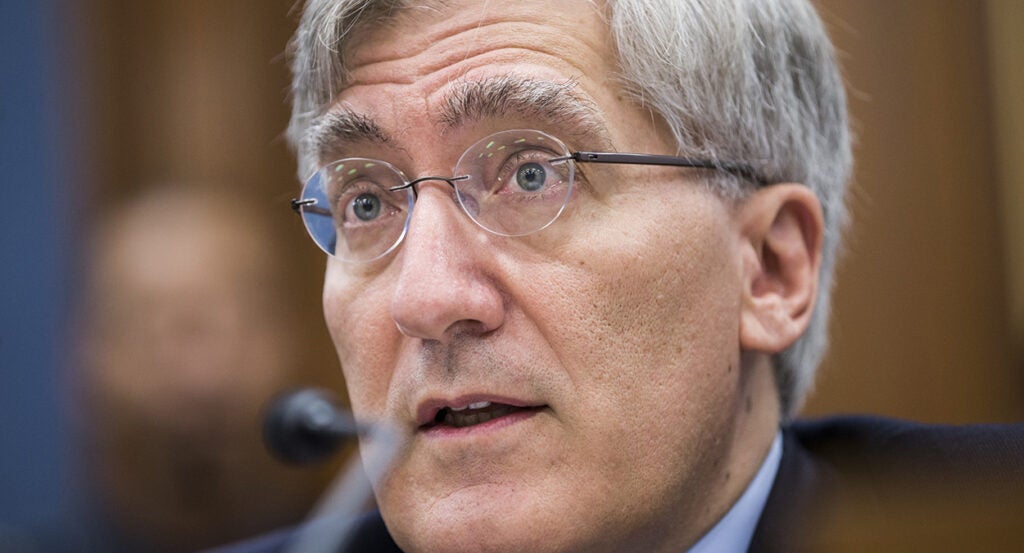 Robert P. George testifies in a suit wearing glasses