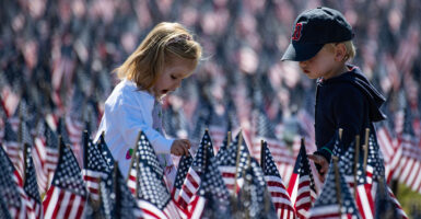 two children in a field of thousands of U.S. flags