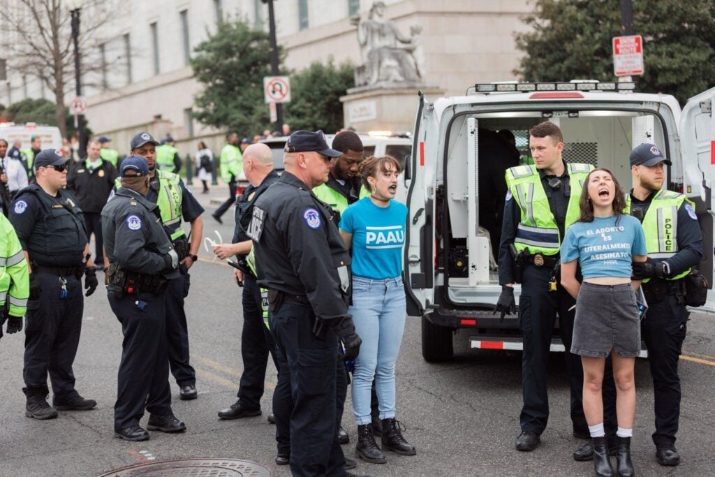 Police arrest members of PAAU for blocking the road as they demonstrated about "The Five." Photo courtesy of Elise Ketch.