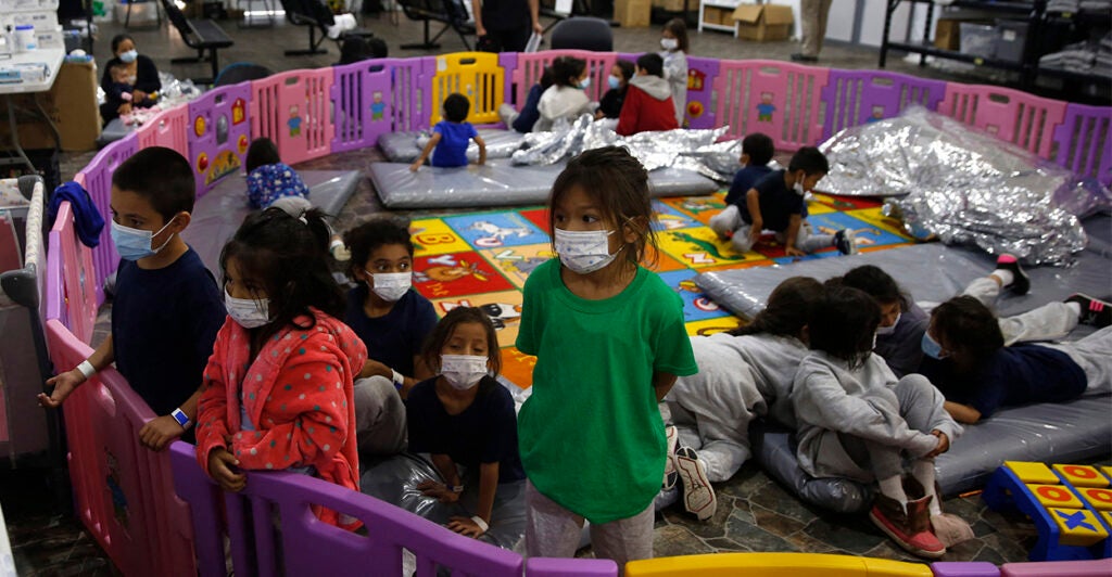 Unaccompanied immigrant children, ages 3-9, inside a playpen at a U.S. detention center