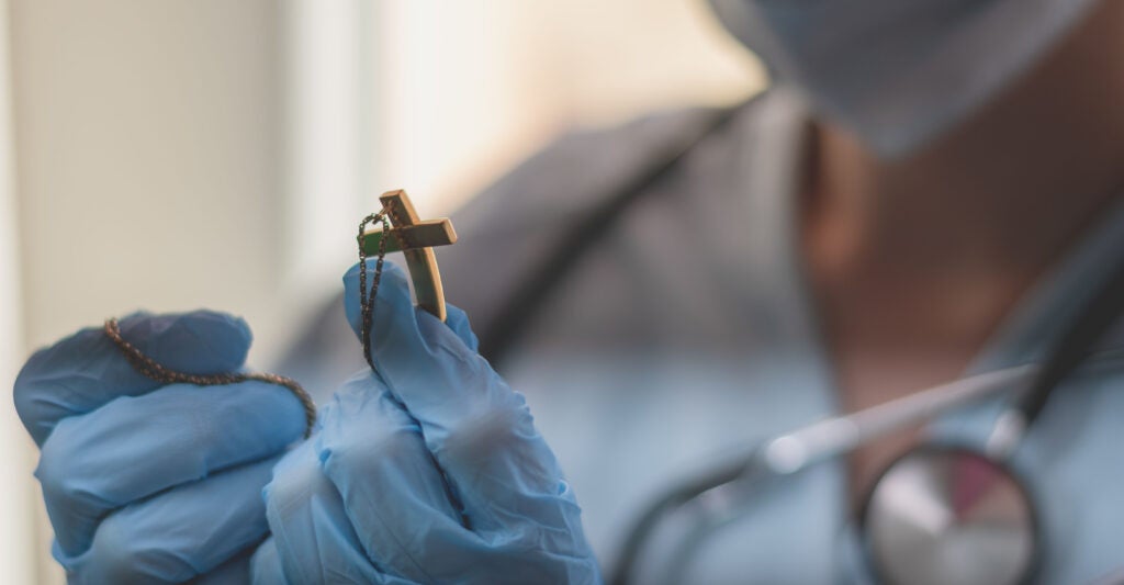 Catholic doctor holds crucifix