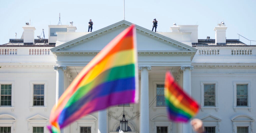 A prominent Washington, D.C. restaurant group beloved by lawmakers on both sides of the aisle is celebrating Pride Month with a weekend drag brunch steps from the White House. Pictured: Demonstrators carry rainbow flags past the White House during the Equality March for Unity and Peace on June 11, 2017 in Washington, D.C. Thousands around the country participated in marches for the LGBTQ communities, the central march taking place in Washington. (Photo by Zach Gibson/Getty Images)