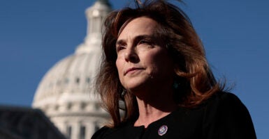 Lisa McClain in black with a congressional pin looks out in front of the Capitol building