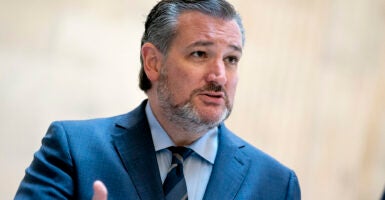 Sen. Ted Cruz gestures while wearing a blue suit