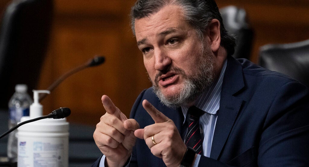 Ted Cruz in a blue suit points while making an argument in the Senate.