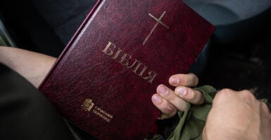 A Ukrainian soldier holds a Bible in Ukrainian