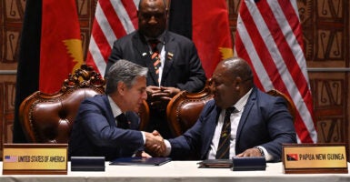 Secretary of State Antony Blinken and Papua New Guinea's Defense Minister Win Bakri Daki shake hands