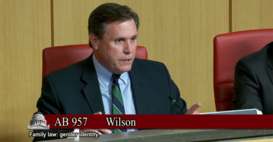 Scott Wilk in a suit speaks at a desk