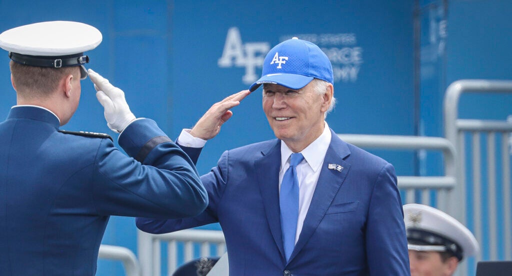 President Joe Biden salutes in a blue suit