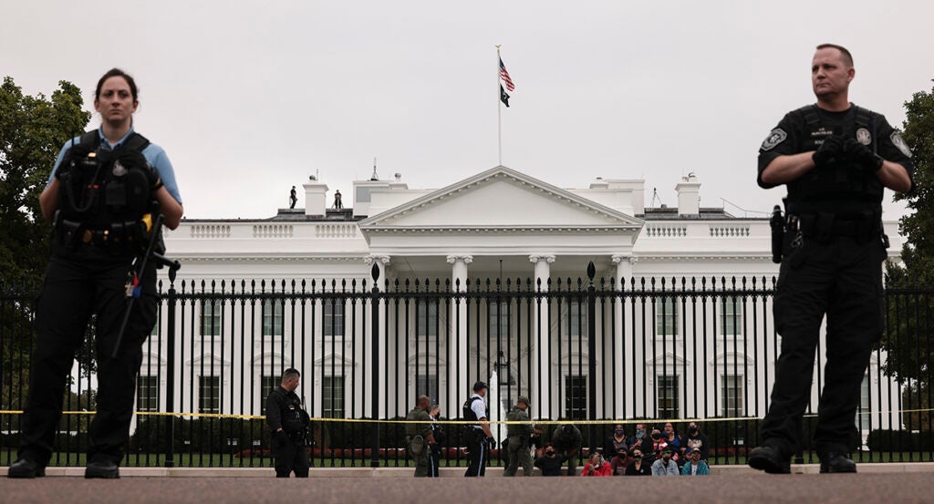 Secret Service stand in front of the White House