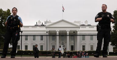 Secret Service stand in front of the White House