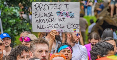 Protester holds sign reading 