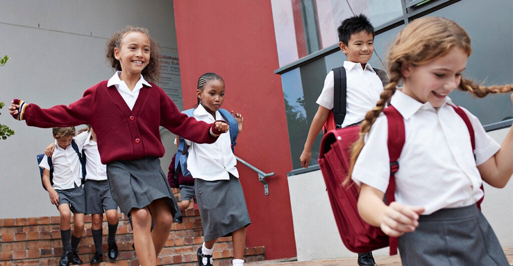 Children at a private school running outside for recess