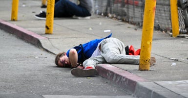 Man passed out on street.