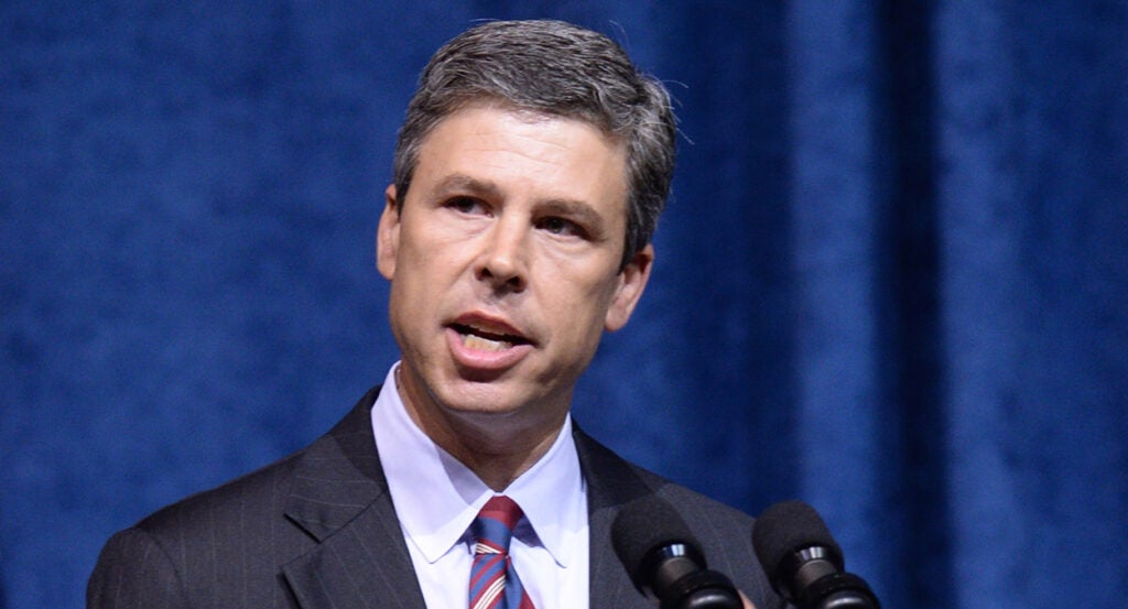 Chattanooga Mayor Andy Berke speaks in a pin-stripe grey suit