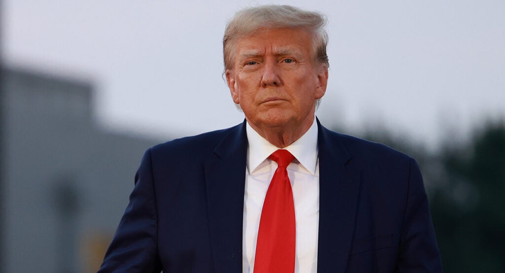 Donald Trump in a blue suit with a red tie