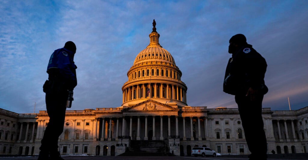 The United States Capitol Police have ordered senate offices to shelter in place due to a "concerning 911 call." Pictured: Capitol Police Officers stand on the East Plaza of the Capitol Campus as the dome of the U.S. Capitol Building is illuminated by the rising sun on Capitol Hill on Thursday, Jan. 6, 2022 in Washington, DC. (Kent Nishimura / Los Angeles Times via Getty Images)