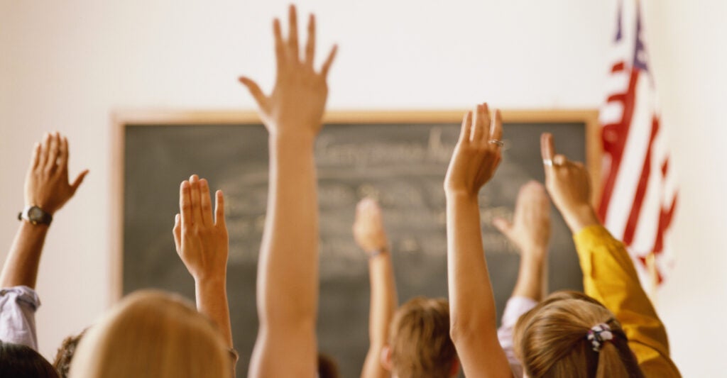 hands raised in a classroom