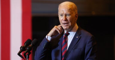 Joe Biden in a blue suit with a striped red and blue tie.