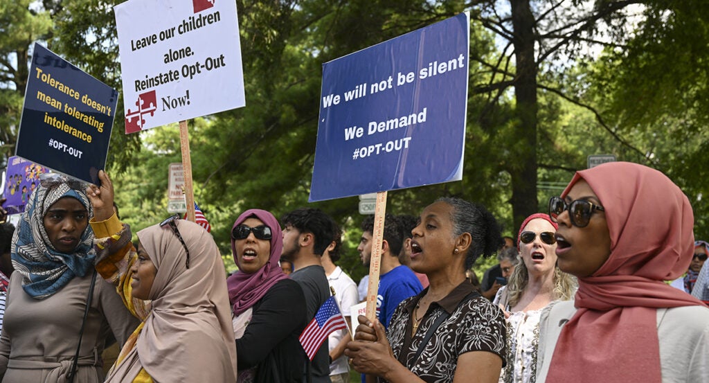 Montgomery County parents in hijabs and wearing crosses protest