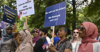 Montgomery County parents in hijabs and wearing crosses protest