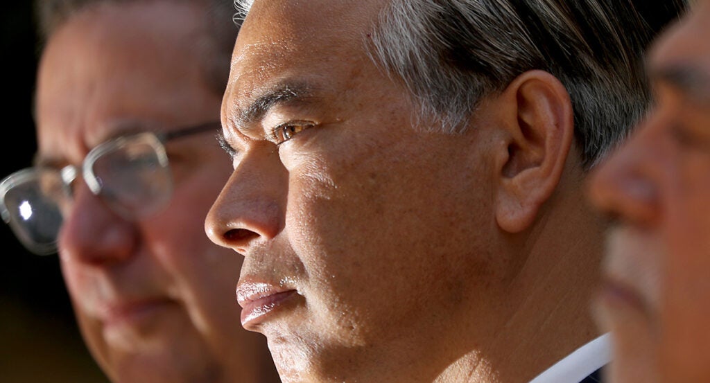 Rob Bonta in a suit looks to the left