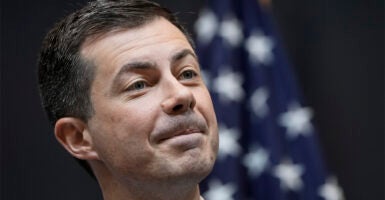 Secretary Pete Buttigieg in front of American flag