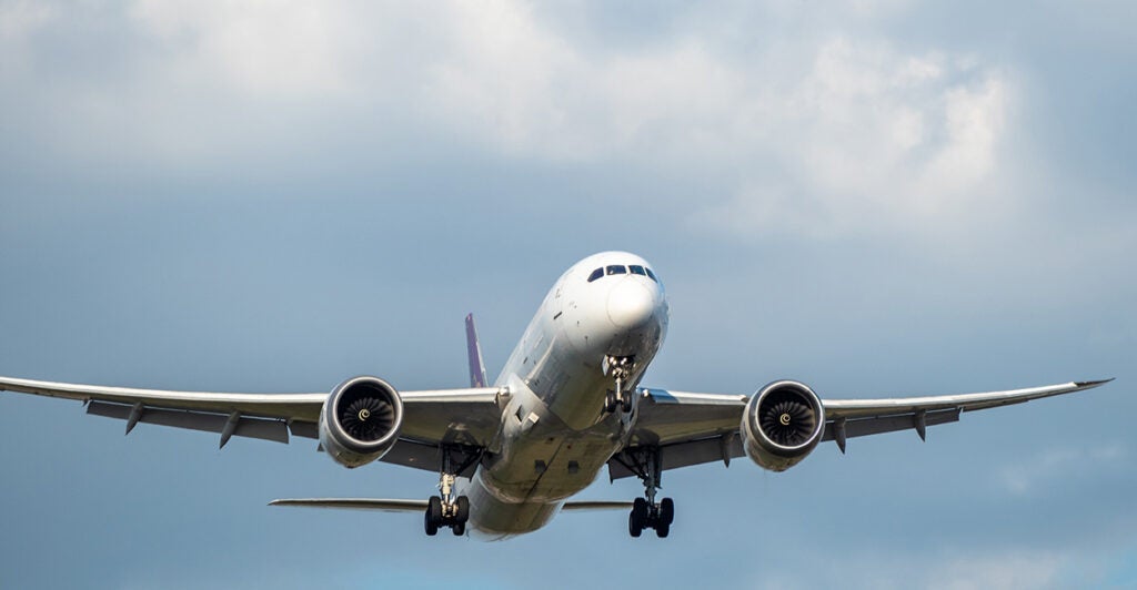 An airplane is seen flying in the sky.