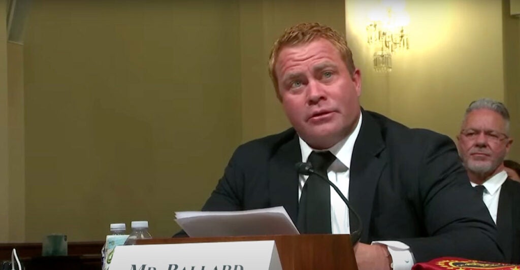 Tim Ballards speaks into a microphone while seated before Congress.