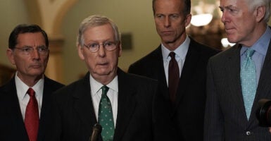 John Barrasso, Mitch McConnell, John Thune, and John Cornyn stand in suits