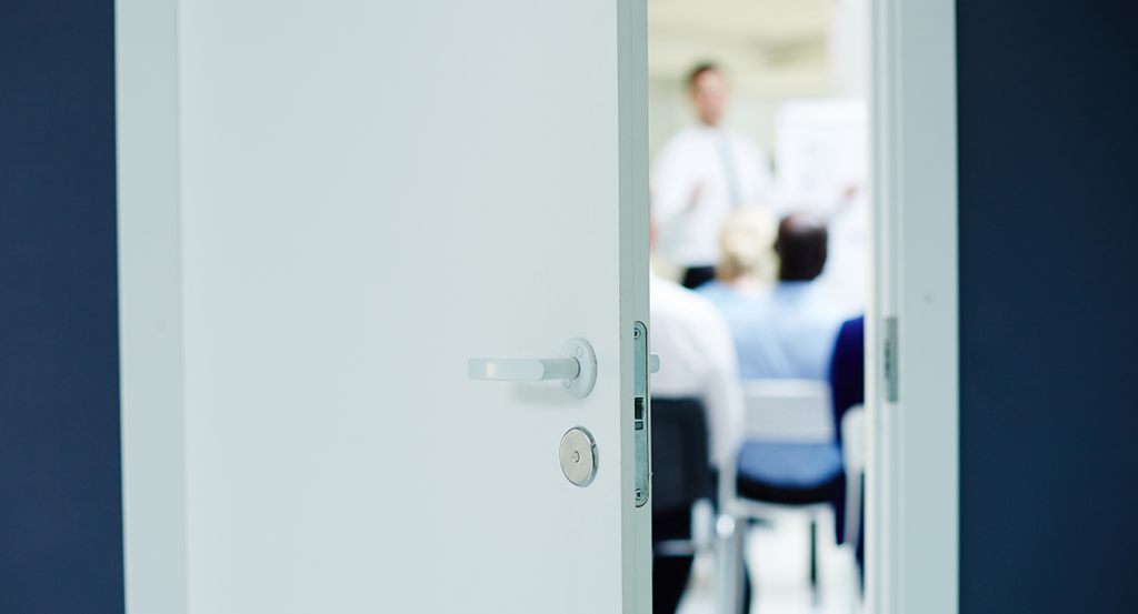 kids in class behind half-open door