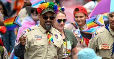 Boy Scouts in uniform march in pride parade