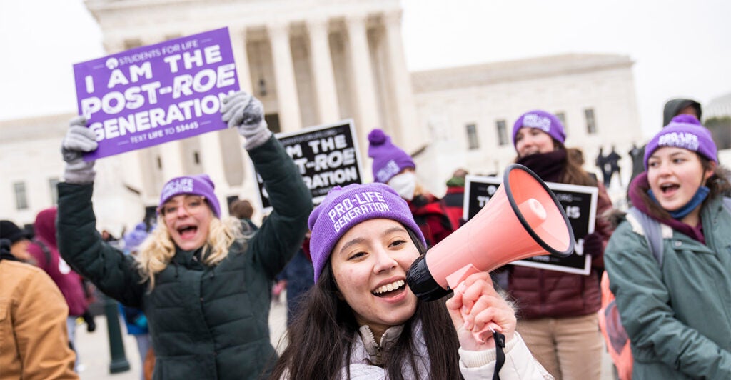 Pro-lifers rally with signs outside the Supreme Court