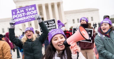 Pro-lifers rally with signs outside the Supreme Court