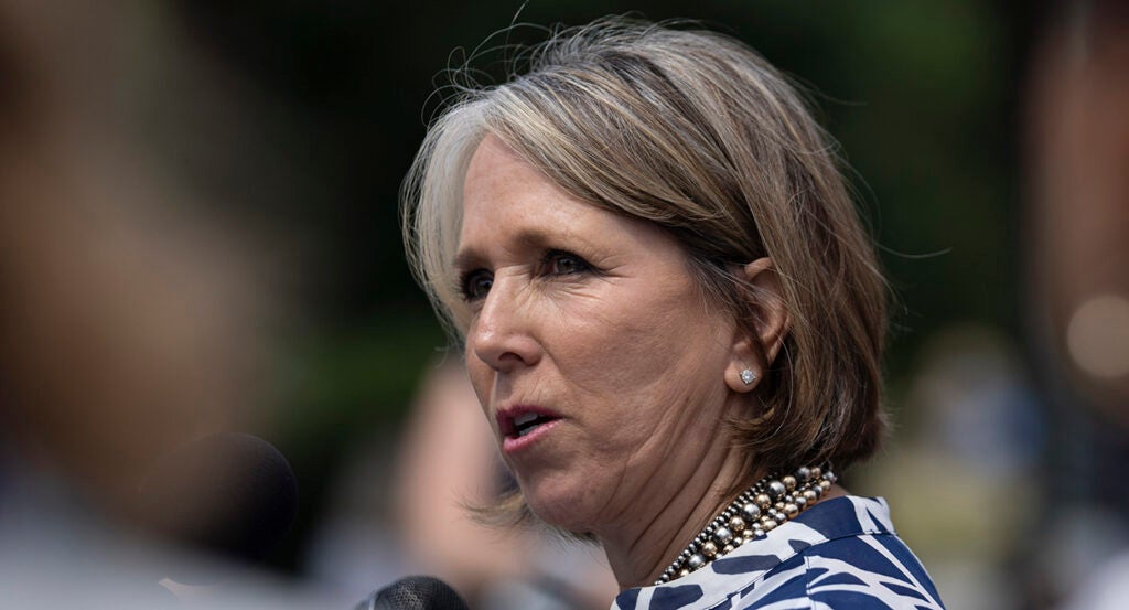 Michelle Lujan Grisham wearing a pearl necklace and earrings