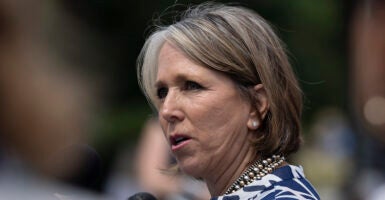 Michelle Lujan Grisham wearing a pearl necklace and earrings