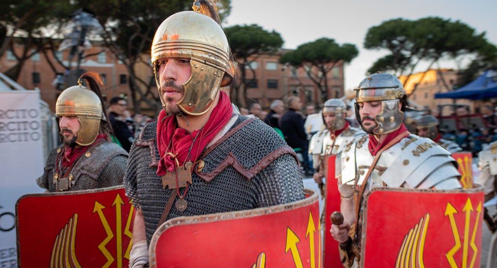 Mean wear chain mail and carry shields reminiscent of legions in the Roman Empire.