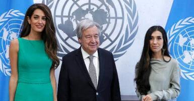 United Nations Secretary-General Antonio Guterres, in a suit, meets with Amal Clooney and Nadia Murad